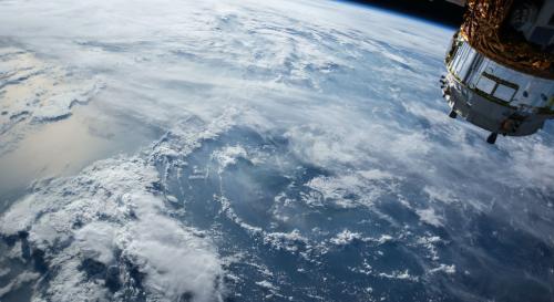 An image of the earth from space, plus a satellite