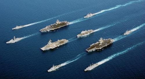 Four modern aircraft carriers of various types—USS John C. Stennis, Charles de Gaulle (French Navy), USS John F. Kennedy, helicopter carrier HMS Ocean—and escort vessels, 2002