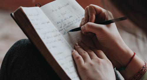 woman writing in a notebook
