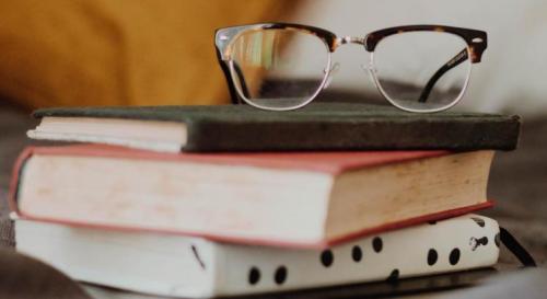 Glasses on a pile of books
