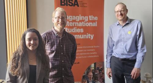 Working group convenors posing in front of a BISA banner
