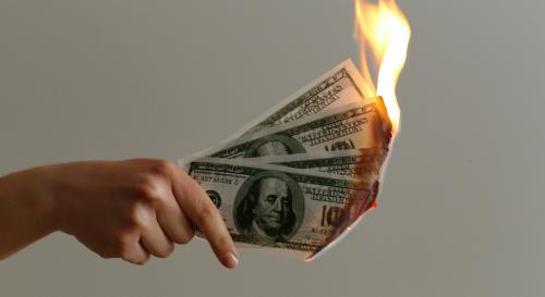 Piece of money on fire