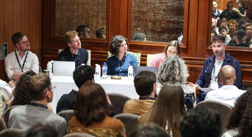 A panel at the Europa Hotel during #BISA2025, consisting of five panelists and a full auditorium