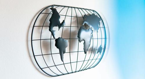 metal abstract globe against white wall