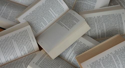 A shot from above of a pile of open books