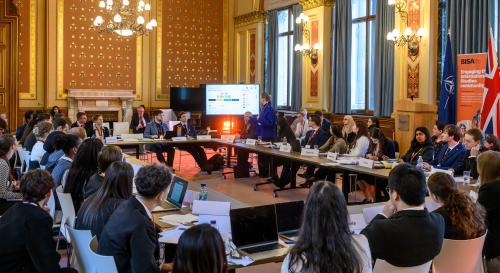 A group of students around a table at FCDO for BISA/FCDO Model NATO 2025