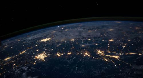 Arial shot of the earth at night with lights lit up on the earth 