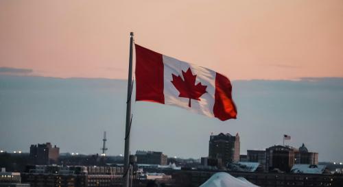 City skyline with a Canadian flag and a sunset 