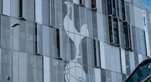 Tottenham stadium with the logo on the side