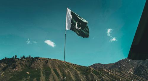 Pakistani flag flying over a mountain