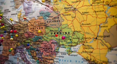 Multicoloured close up shot of a map with multicoloured pins inserted into it