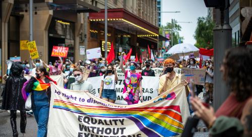 LGBTQ+ march holding a banner with the words equality without exemptions 