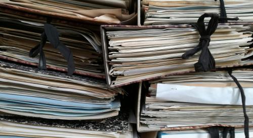 Multiple large stacks of bound together papers