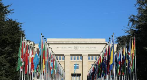 UN headquarters with a line of countries flags leading to the entrance