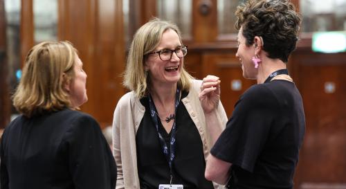 3 women laughing in a circle