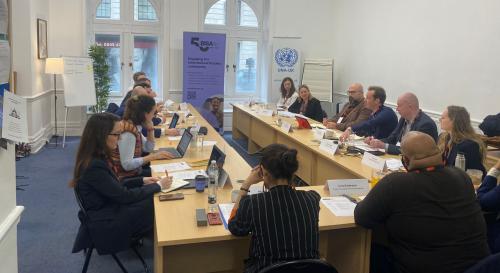 Participants round a table at the BISA policy lab on AI