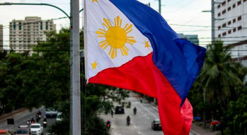 close up shot of a Filipino flag waving above a street