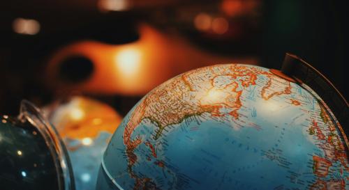 close up shot of a globe in a warmly lit room 