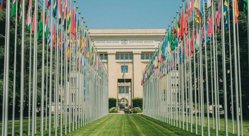 walkway up to the UN general assembly with rows of flags either side 