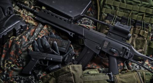 Black rifle with bullets and other accessories